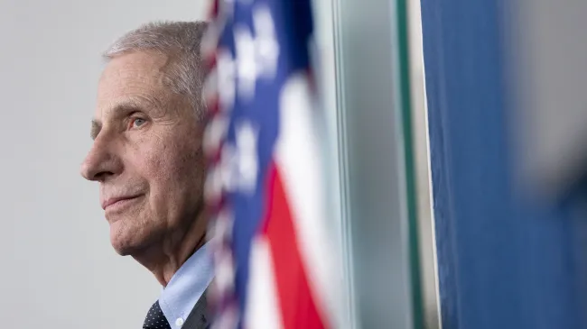 Dr. Anthony Fauci watches on during a press conference